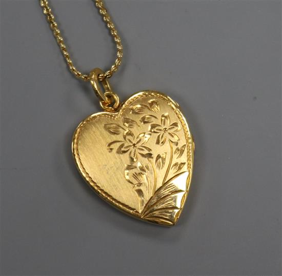 A Chinese gold locket (stamped 22K) on 18ct gold fine suspension chain.